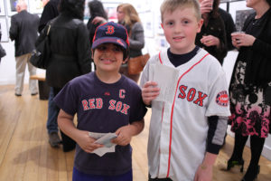 Two young boys in Red Sox uniforms