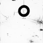 An abstract of a tire hanging in snow