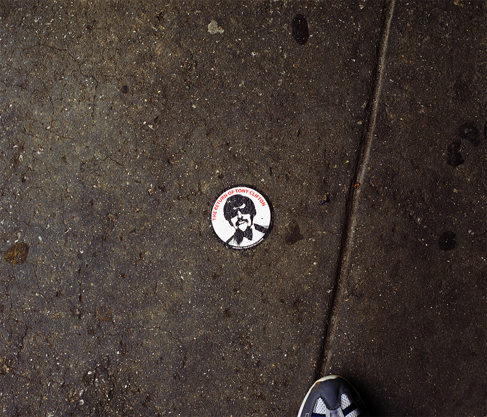 a crack in the sidewalk with a sticker