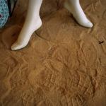 a mannakin's feet on dirt