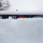 The front of a house with deep snow