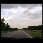 an open road with stripe in middle of road