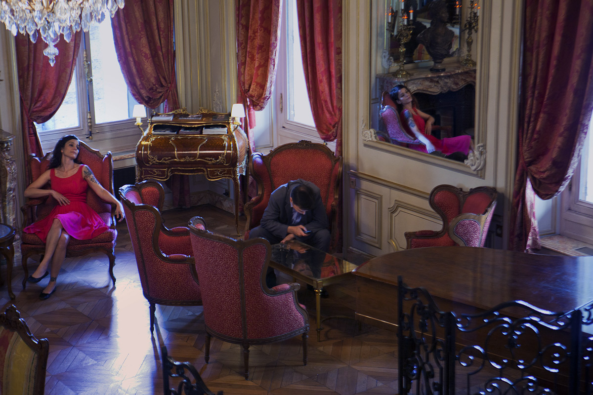 A man and woman sit in easy chairs talking.