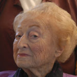 An elderly woman poses with new hair doo.