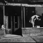 A person is in a store window cleaning glass