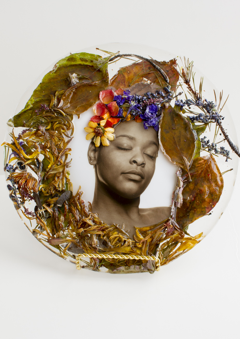 African American woman surrounded by wreath of flowers