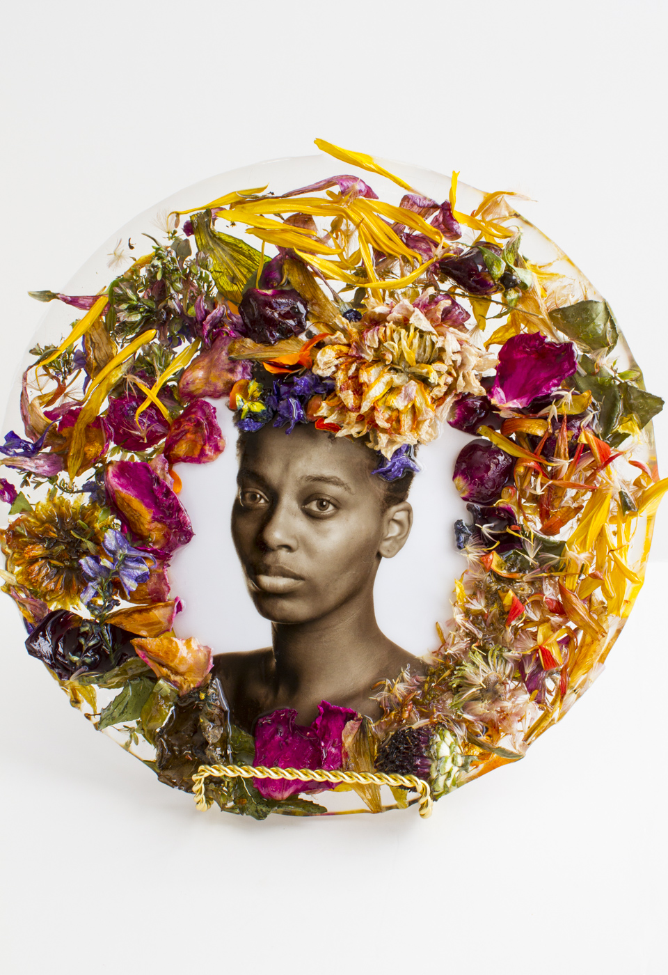 African American woman surrounded by wreath of flowers