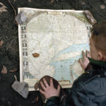 A boy looking at a map.