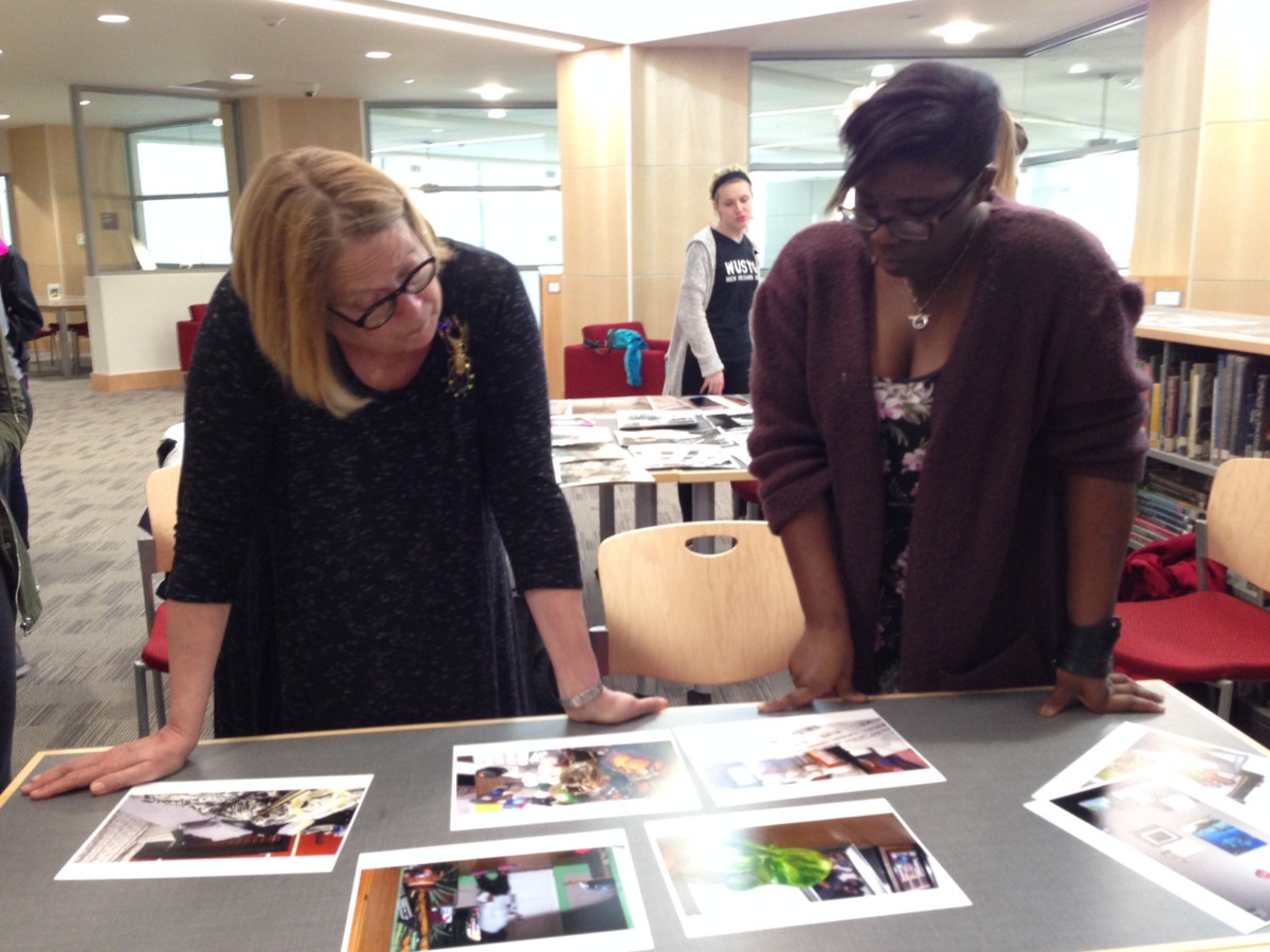 Two women looking at photos