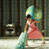 Doll vacuuming and carrying a globe