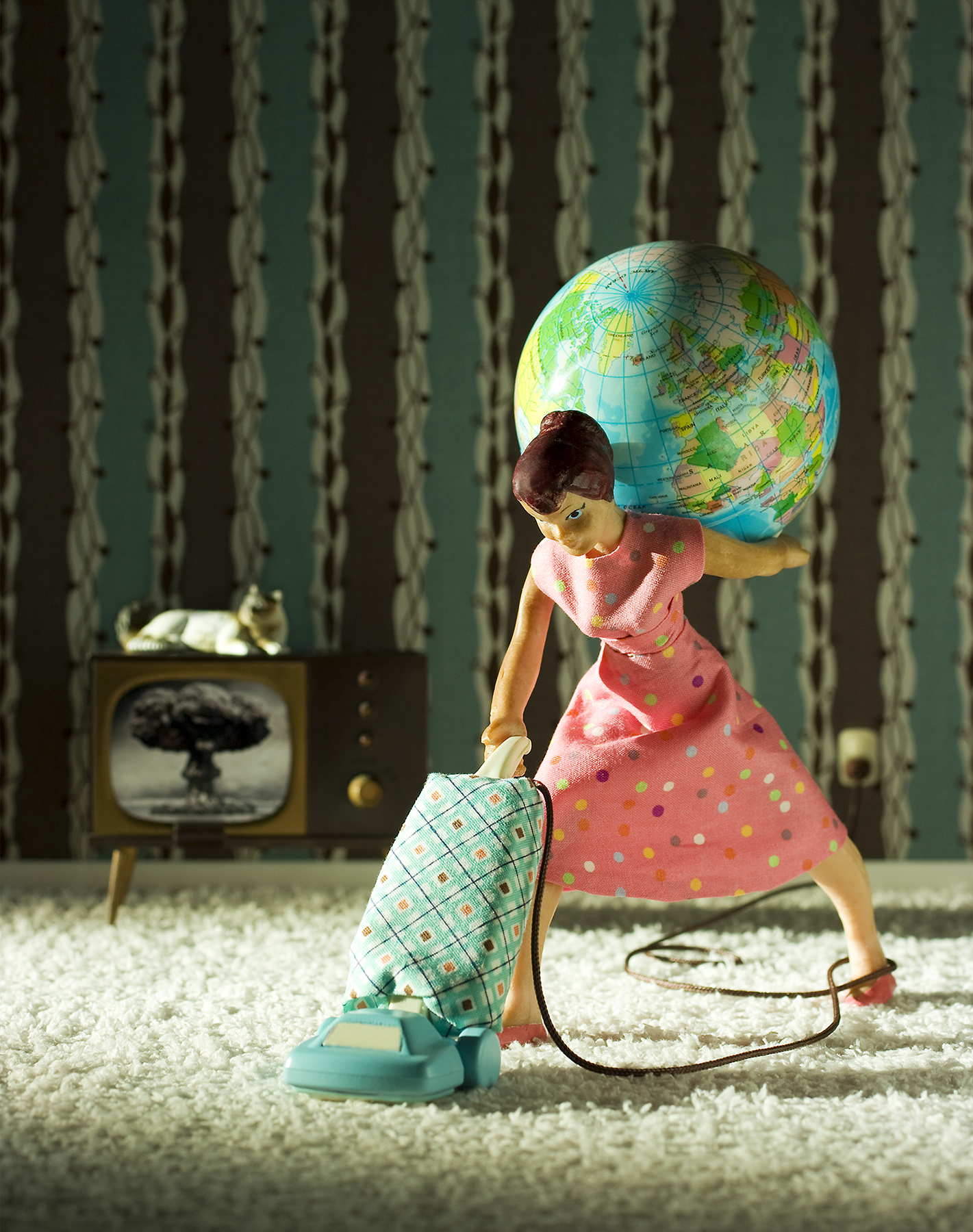 Doll vacuuming and carrying a globe