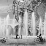 Sphere in fountain with people and bikes