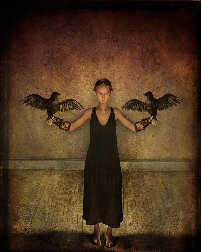 Woman holding 2 blackbirds