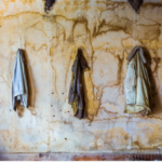 Jackets on yellow stained wall