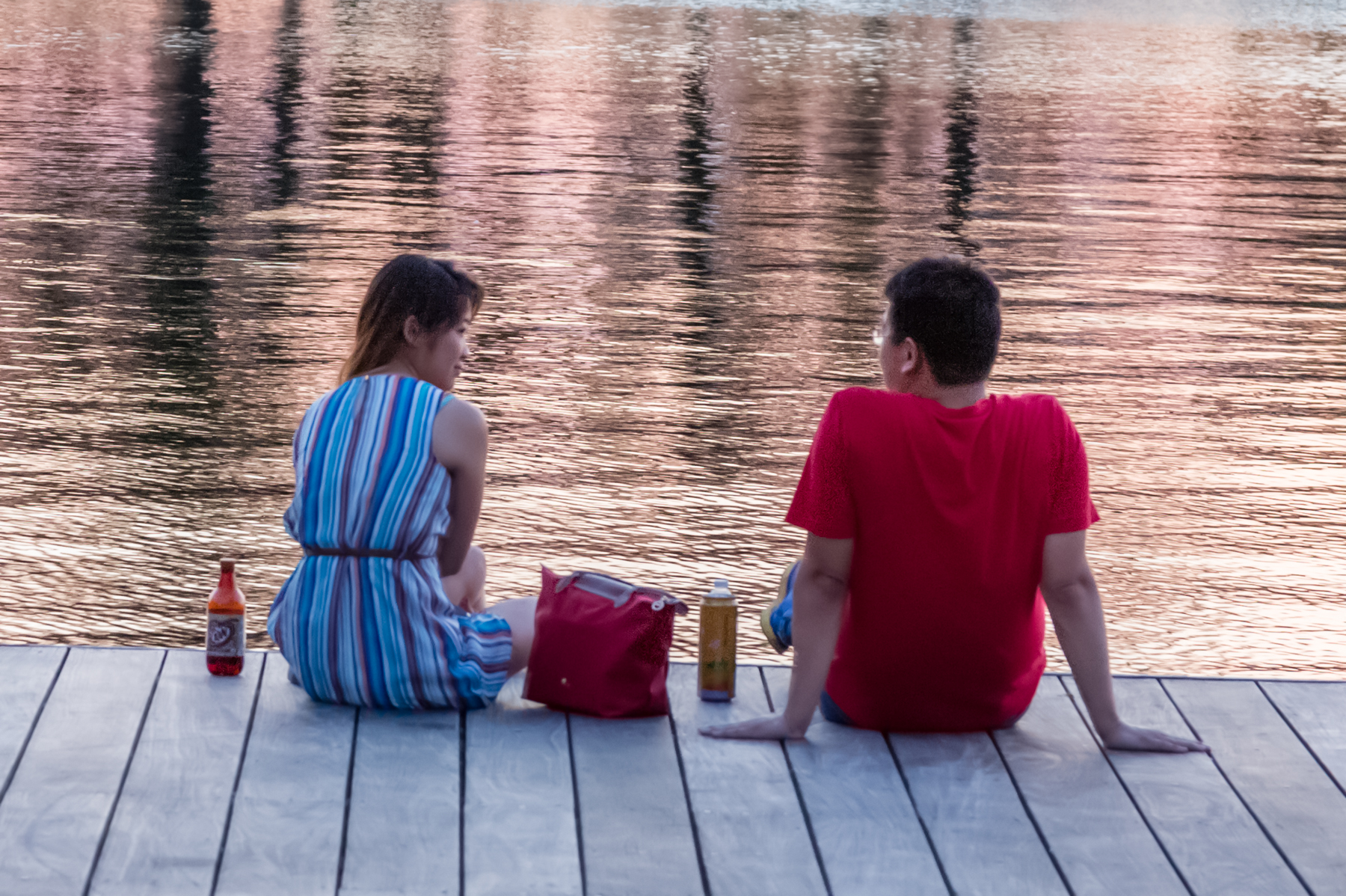 Man and woman sitting on a dock
