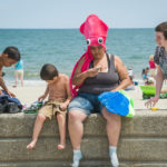 Woman with squid hat and children