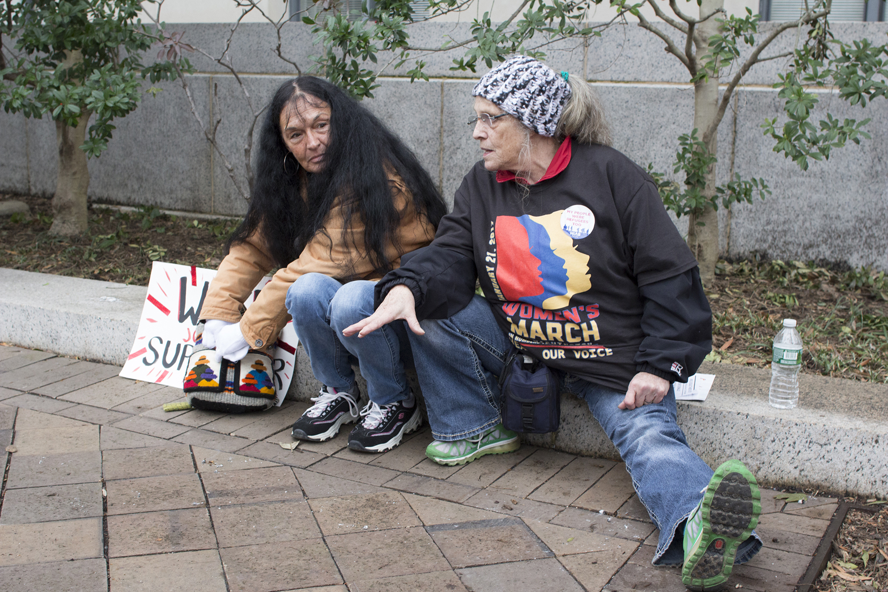 Two people sitting after marching