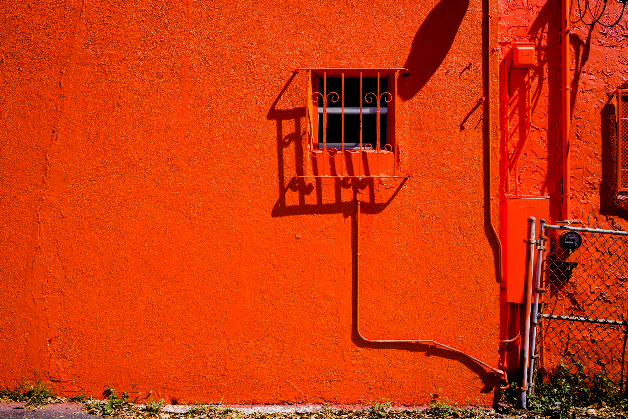 Red wall with barred window