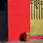 Red wall, gold gate and gold waste barrel