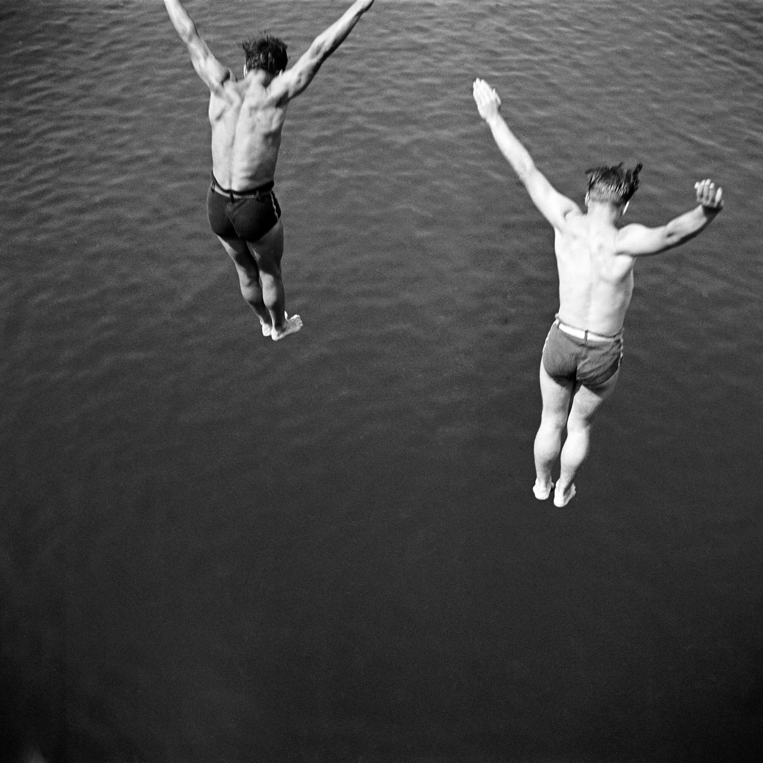 © Arthur Griffin, "Two Boys Jumping". Two boys jump into water.