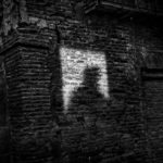 Shadow of a man on a brick wall