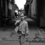Young boy walking down street