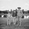 two boys and man in cowboy hats