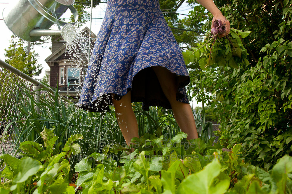 Woman picking food in a garden