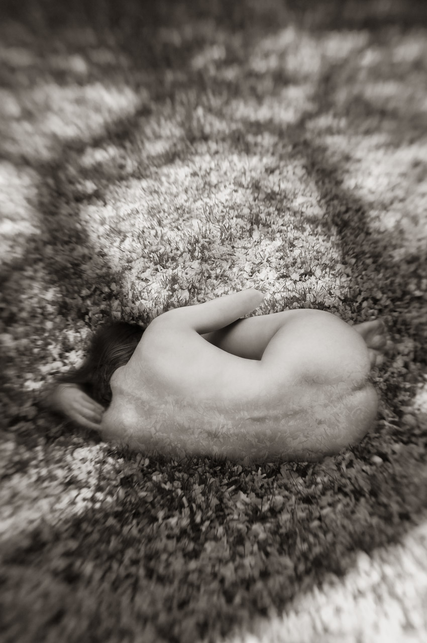 Nude woman lying on the ground