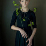 Girl holding green flowers