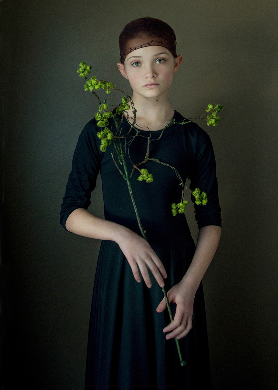 Girl holding green flowers