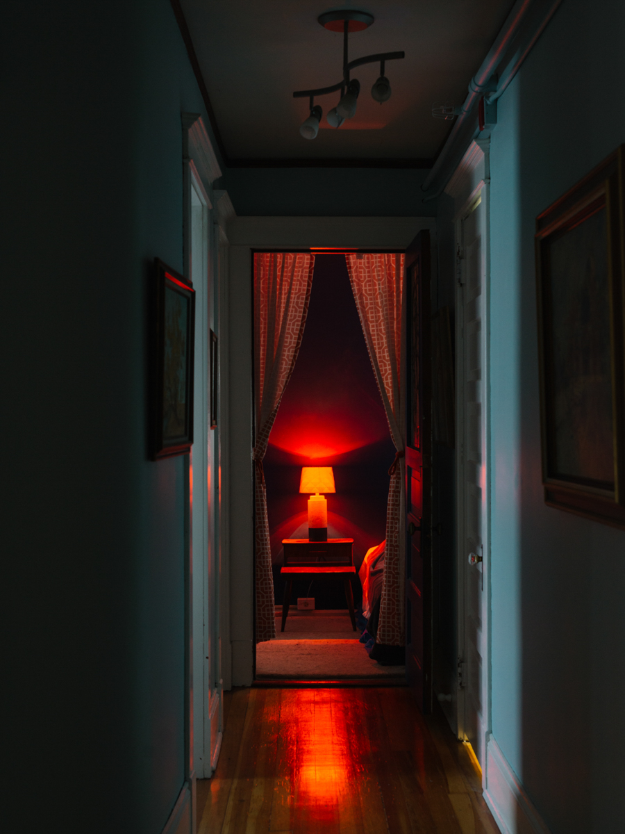 Red lamp and curtains down a hallway