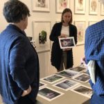 Emily Belz holding a photography during a critique