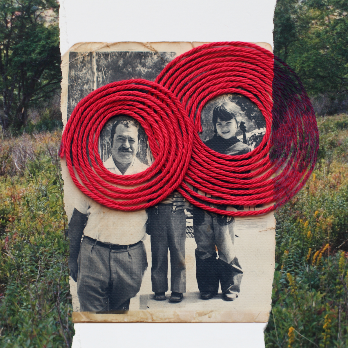 Photo of young girl with older man with red thread circling them