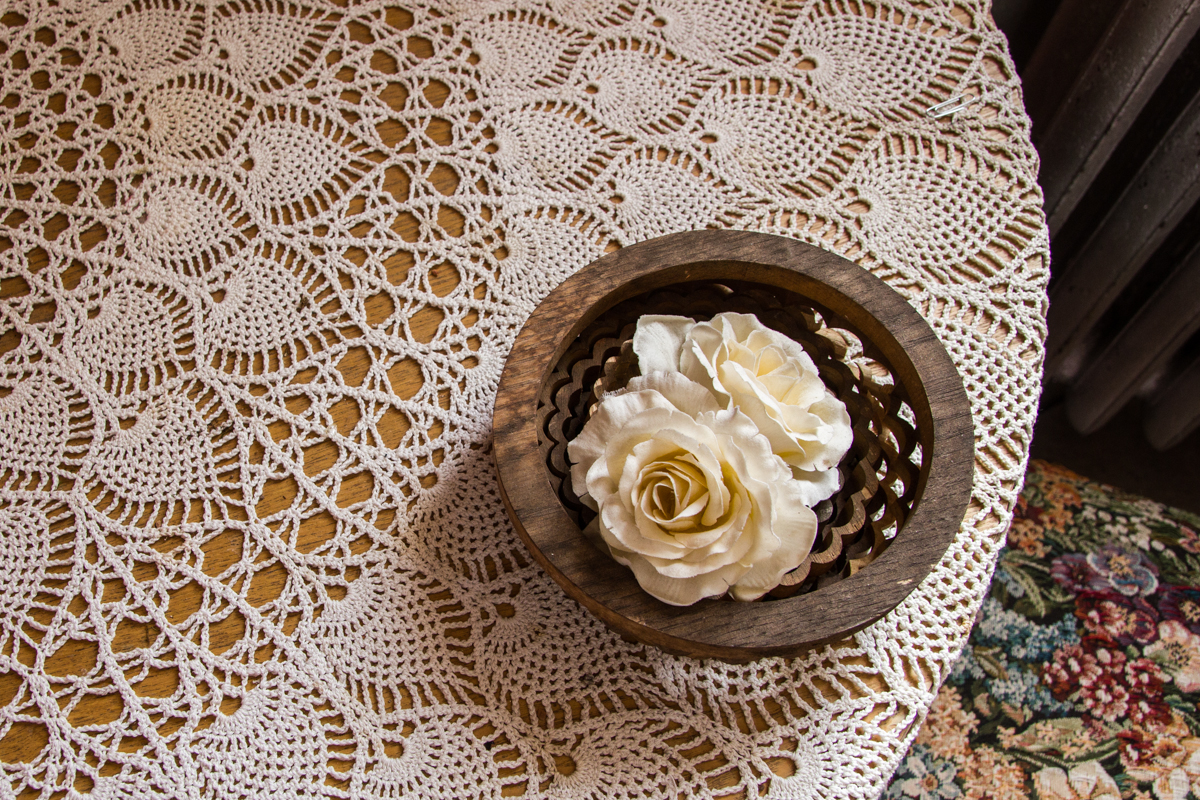 Bowl with flower on a lacy table cloth