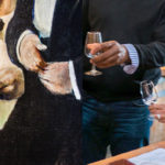 man holding glass of wine