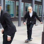 Man on skateboard and man leaving the frame