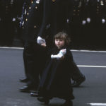 Young child walking with man holding her hand