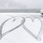 Two hearts made in the snow by tires