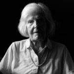 Elderly woman in white shirt with black background. © Virgil DiBiase, "I don’t want to be the way I am right now.” - Mary Lou