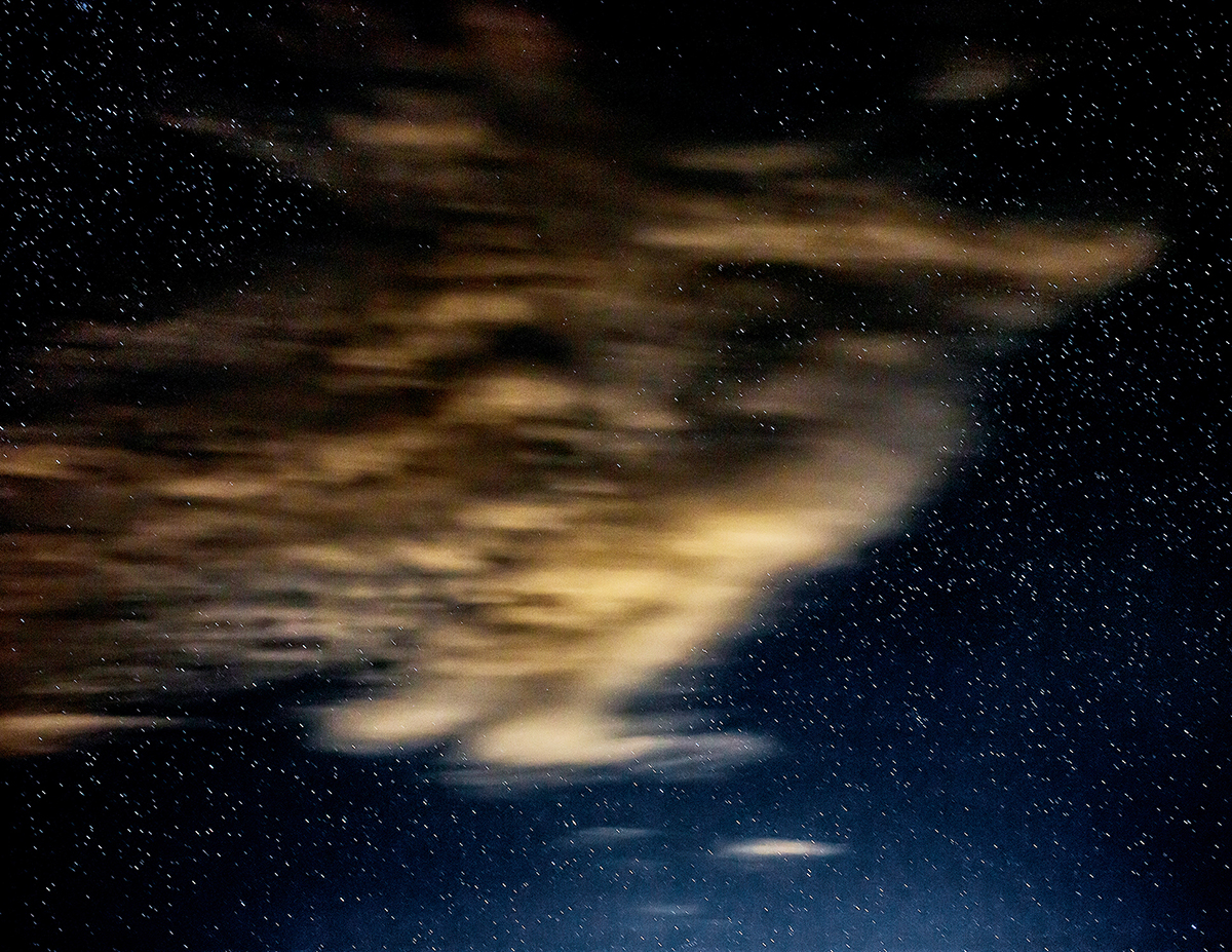A passing cloud and a background of stars