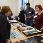 Photographers with portfolios on table