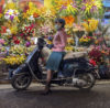 woman on motor bike with face mask