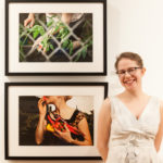 Ivana George standing in front of two framed photographs