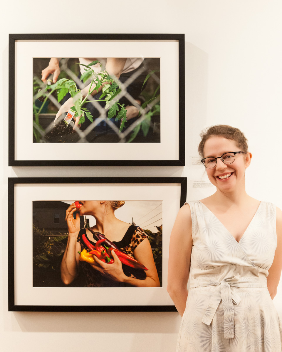 Ivana George standing in front of two framed photographs