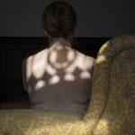 woman sitting with shadow on back