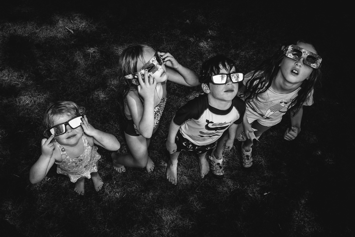 Four Children Looking at a Solar Eclipse