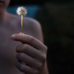 child with dandelion