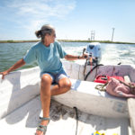 woman and dog in boat