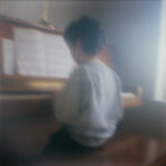 Boy sitting at piano